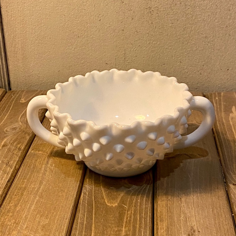 White little cup with handles.
